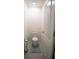 Compact powder room with a standard toilet, neutral tile, and fresh decor at 5062 Foxglove Cir, Lakeland, FL 33811