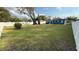 Large grassy backyard with a mature tree and white fence at 515 Crevasse St, Lakeland, FL 33805