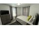 Cozy bedroom with a double bed, gray dresser, and gray curtains at 515 Crevasse St, Lakeland, FL 33805