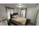 Bright bedroom with a double bed and gray wood-toned furniture at 515 Crevasse St, Lakeland, FL 33805