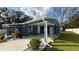 Newly renovated blue house with carport, landscaped yard, and white fence at 515 Crevasse St, Lakeland, FL 33805