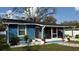 Cute blue house with screened porch and landscaped yard at 515 Crevasse St, Lakeland, FL 33805