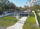 Charming blue home featuring a well manicured lawn, an extra long driveway, and mature landscaping at 515 Crevasse St, Lakeland, FL 33805