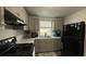 Updated kitchen with gray cabinets, marble countertops, and black appliances at 515 Crevasse St, Lakeland, FL 33805