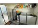 Laundry room with washer, dryer, water heater, and shelving at 515 Crevasse St, Lakeland, FL 33805