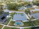 Aerial shot of home with screened pool enclosure, white vinyl fence, and lush backyard at 5155 Lake Deeson Woods Ct, Lakeland, FL 33805