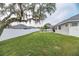 Expansive backyard featuring a well-maintained lawn, white fencing and mature trees at 5155 Lake Deeson Woods Ct, Lakeland, FL 33805