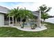 Backyard with small palm trees and white rocks along the screened in lanai with a pool at 5155 Lake Deeson Woods Ct, Lakeland, FL 33805