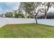 Spacious backyard with lush green grass and white vinyl fencing for privacy at 5155 Lake Deeson Woods Ct, Lakeland, FL 33805