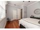 Neutral bedroom features hardwood floors, a rocking chair and decor above the dark dresser at 5155 Lake Deeson Woods Ct, Lakeland, FL 33805