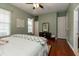 Bedroom with hardwood floors featuring an area rug, full bed and natural light entering through large windows at 5155 Lake Deeson Woods Ct, Lakeland, FL 33805
