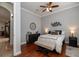 This bedroom has hardwood flooring, an area rug, a comfortable bed, a dresser, and plenty of natural light at 5155 Lake Deeson Woods Ct, Lakeland, FL 33805
