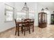 Bright breakfast nook with a wood table set and a window view, complemented by a stylish display cabinet at 5155 Lake Deeson Woods Ct, Lakeland, FL 33805