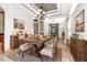Elegant dining room with a rustic wood table and stylish chandelier, virtually staged at 5155 Lake Deeson Woods Ct, Lakeland, FL 33805