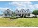 Charming single-Gathering home featuring a welcoming front porch, lush lawn, and manicured landscaping for great curb appeal at 5155 Lake Deeson Woods Ct, Lakeland, FL 33805