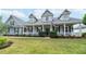 Inviting two-story home with a welcoming front porch and beautifully landscaped yard at 5155 Lake Deeson Woods Ct, Lakeland, FL 33805