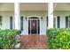 Charming front door with sidelights and a decorative heart, framed by lush greenery at 5155 Lake Deeson Woods Ct, Lakeland, FL 33805