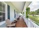 Relaxing front porch with seating, white columns and beautiful hanging plants at 5155 Lake Deeson Woods Ct, Lakeland, FL 33805