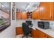 Cozy home office with custom cherry cabinets, granite countertops, and a built-in desk for work and storage at 5155 Lake Deeson Woods Ct, Lakeland, FL 33805
