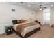 Spacious main bedroom featuring neutral carpeting, a ceiling fan, and natural light from a large window at 5155 Lake Deeson Woods Ct, Lakeland, FL 33805
