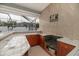 Outdoor bar features tile counters, backsplash and cabinets below with a metal sign at 5155 Lake Deeson Woods Ct, Lakeland, FL 33805