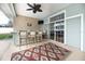 Covered patio area showcases an outdoor kitchen and a bar with seating and ceiling fan at 5155 Lake Deeson Woods Ct, Lakeland, FL 33805