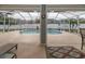 View of the pool with a seating area and a geometric patterned rug under the lanai at 5155 Lake Deeson Woods Ct, Lakeland, FL 33805