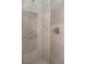 Close-up of shower showcasing marble-look tile walls, a brass shower handle, and clean lines for a spa-like feel at 5155 Lake Deeson Woods Ct, Lakeland, FL 33805