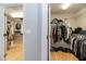 Organized walk-in closet with ample hanging space, shelving, and wood flooring, offering practical storage solutions at 5155 Lake Deeson Woods Ct, Lakeland, FL 33805