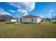 Spacious backyard showcasing the property's well-maintained lawn and exterior structure at 519 Eagle Ct, Kissimmee, FL 34759