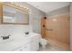 Bathroom with double sink vanity, gold framed mirror, gray walls, and tiled shower with safety bar at 519 Eagle Ct, Kissimmee, FL 34759