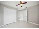 The bedroom features tile flooring, neutral paint, and a ceiling fan, along with a closet for storage at 519 Eagle Ct, Kissimmee, FL 34759