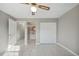 This bedroom features a ceiling fan, closet, tile floors and an ensuite bathroom with a sink and mirror at 519 Eagle Ct, Kissimmee, FL 34759