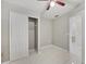 Bedroom featuring tile flooring, neutral paint, a ceiling fan, and a closet for storage solutions at 519 Eagle Ct, Kissimmee, FL 34759