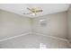 This bedroom features neutral paint, ceiling fan and tile flooring at 519 Eagle Ct, Kissimmee, FL 34759