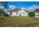 Inviting single-story home with lush lawn, driveway, and two-car garage, under a sunny sky at 519 Eagle Ct, Kissimmee, FL 34759