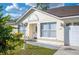 Inviting home exterior showcasing a manicured lawn, walkway and a quaint front entrance at 519 Eagle Ct, Kissimmee, FL 34759