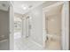 Hallway view of bathroom and living room with tile floors, neutral colors and modern fixtures at 519 Eagle Ct, Kissimmee, FL 34759