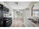 Bright kitchen features stainless steel appliances, white cabinetry and a large window with lots of sunlight at 519 Eagle Ct, Kissimmee, FL 34759