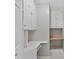 This storage room has white cabinets and desk space with shelving for organized storage at 519 Eagle Ct, Kissimmee, FL 34759