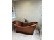 Unique bathroom features a freestanding copper soaking tub and large window at 528 Laurel Ln, Lakeland, FL 33813