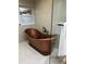 Unique bathroom features a freestanding copper soaking tub and large window at 528 Laurel Ln, Lakeland, FL 33813