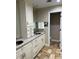 Bathroom features custom double vanity with marble countertop, and ample storage at 528 Laurel Ln, Lakeland, FL 33813