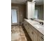Bathroom features a double sink vanity with marble countertop and ample storage at 528 Laurel Ln, Lakeland, FL 33813