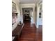 Inviting home hallway featuring hardwood floors, wainscoting, and a glimpse into other rooms at 528 Laurel Ln, Lakeland, FL 33813