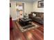 Cozy living room with rich hardwood floors, view of the kitchen, and decorative area rug at 528 Laurel Ln, Lakeland, FL 33813
