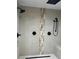 Luxurious shower with dual showerheads and a decorative tile accent stripe at 528 Laurel Ln, Lakeland, FL 33813