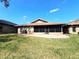 A spacious backyard featuring a patio and green grass at 600 Caribbean Dr, Lakeland, FL 33803