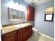 Bathroom features marble countertops, vanity storage, and a modern mirror at 600 Caribbean Dr, Lakeland, FL 33803