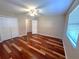 Bedroom featuring hardwood floors, ceiling fan and closet at 600 Caribbean Dr, Lakeland, FL 33803